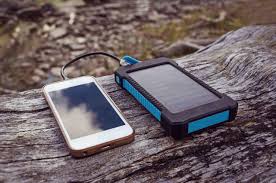 Portable solar panel charging a phone in sunlight