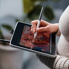 Student taking notes on a tablet with stylus